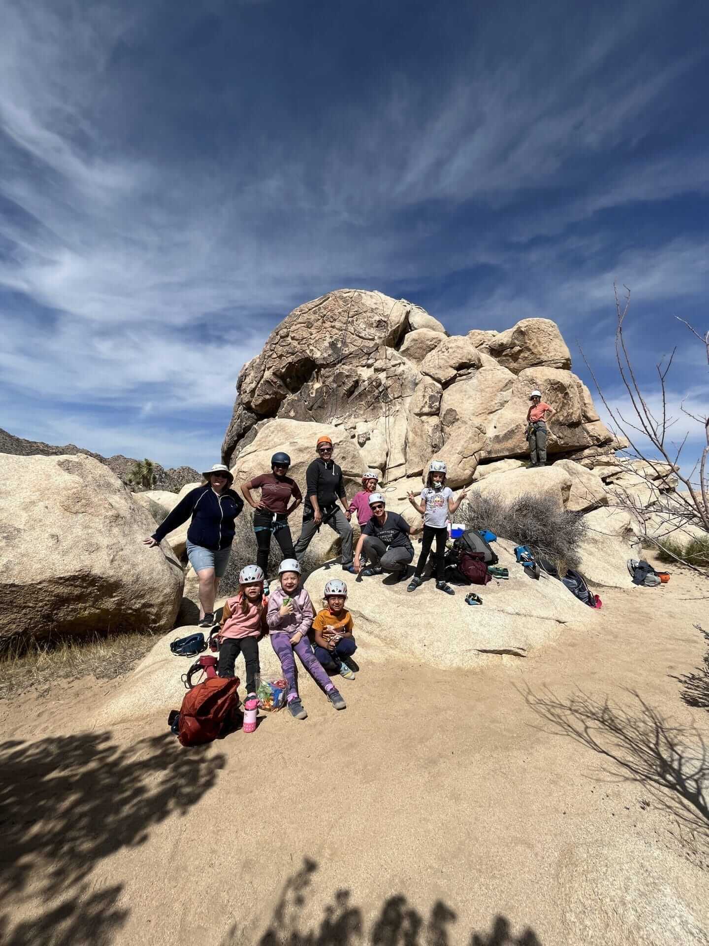 picture of family with a big rock behind