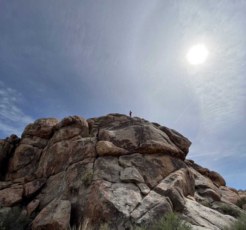 man standing at the top of a mountain